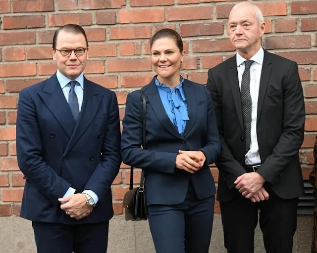 Crown Princess Victoria wore a navy suit, blazer and pants, by Tiger of Sweden, and an Irina blue frilled tie blouse by Mayla Stockholm