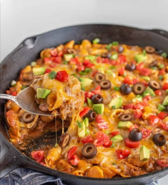 Skillet Taco Pasta is a flavorful and satisfying one-pan dish that combines the best of both worlds: the bold and spicy flavors of tacos and the comforting appeal of pasta. In this recipe, ground meat (usually beef or turkey) is browned and seasoned with taco spices like chili powder, cumin, and paprika. Then, pasta, typically rotini or penne, is added along with diced tomatoes and sometimes black beans or corn. This all cooks together in a skillet, with the pasta absorbing the rich flavors of the taco seasoning and tomato sauce. Topped with cheese and garnished with fresh cilantro, it's a delicious, family-friendly meal that brings the taste of tacos to your dinner table with a delightful twist.