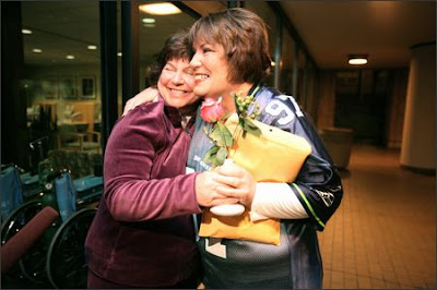 Annamarie Ausnes, left, greets barista Sandie Andersen with a rose on Andersen's arrival at Virginia Mason Medical Center for the kidney transplant surgery Tuesday. All went fine. 