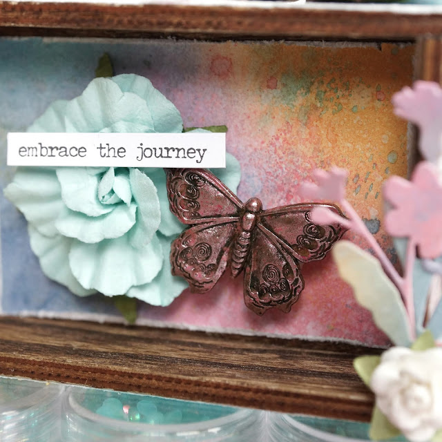 Embrace the Journey mixed media mini vignette with inked background: Tim Holtz mini vignette box, distress oxide inks, blending brush, distress glaze, funky floral and funky nature die cuts, metal butterfly adornment, small talk sticker; Pima With Love paper flowers; Scrapbook.com mint tape, solar white cardstock