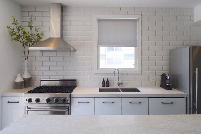 Beautiful white and rustic modern farmhouse style kitchen with black and white decor on Hello Lovely Studio