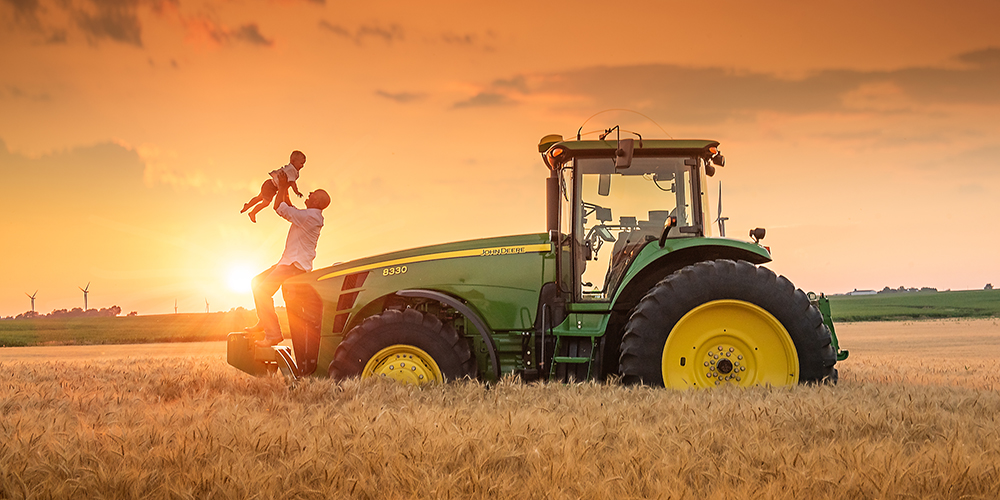 Family photo in wheat field with John deere tractor at sunset best family photographer