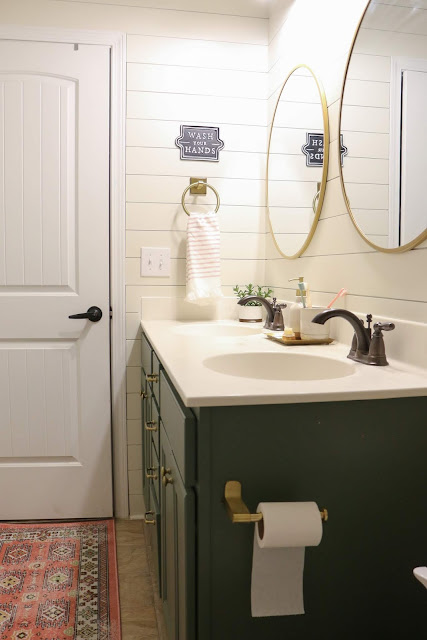 basic builder bathroom updated into a pretty kid-friendly bath with shiplap walls