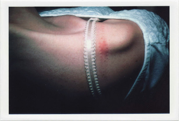 dirty photos - fumus - a photo of girl's shoulder and braw sign