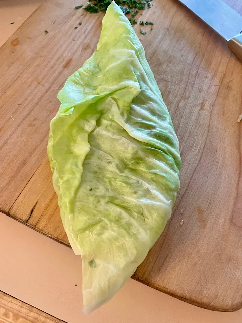 Folding the cabbage leaf.