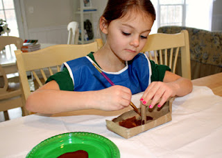 After I stapled the sides of the boat and assembled a good majority of the mast, Tessa painted the boat in her choice of color.