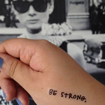 foto de un tatuaje con la frase be strong