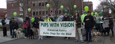 Raisers and pups with banner