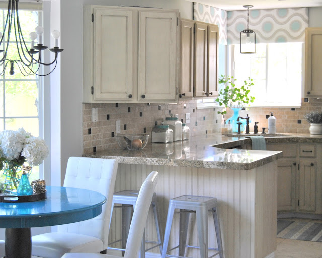 progress lighting, lighting, kitchen lighting, pendant, design, interior design, white kitchen, industrial kitchen, round kitchen table, box valance, kitchen, peninsula, white dining chair, oil rubbed bronze, black lighting, hydrangea, aloof gray, sherwin williams, gray