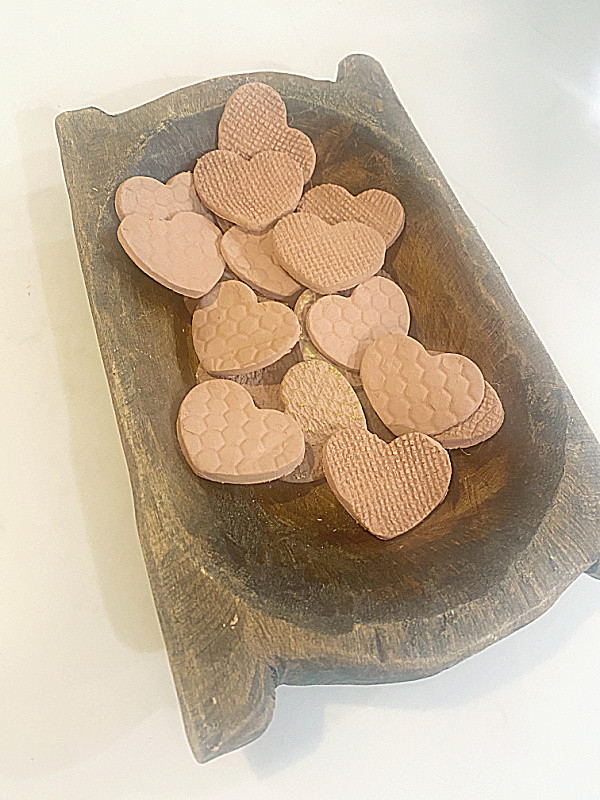 wooden bowl of terra cotta textured hearts
