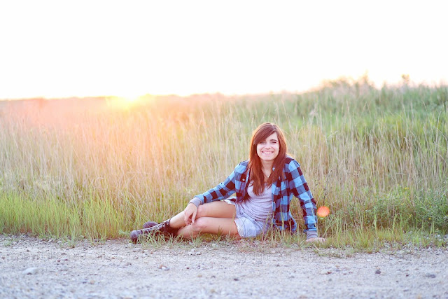 photo of a senior girl sitting beside a country road