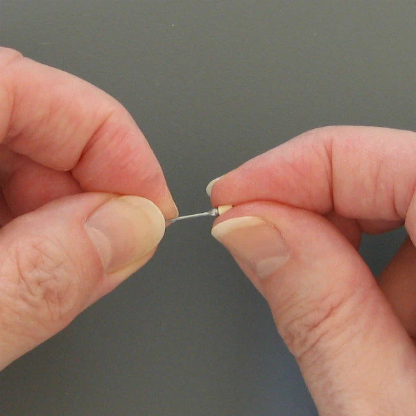 Applying glue inside a quilled tight coil with a ball head pin