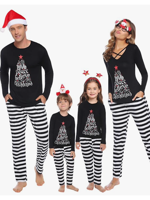 family wearing matching cute christmas pajamas with white and black stripes and a black top with a christmas tree on it