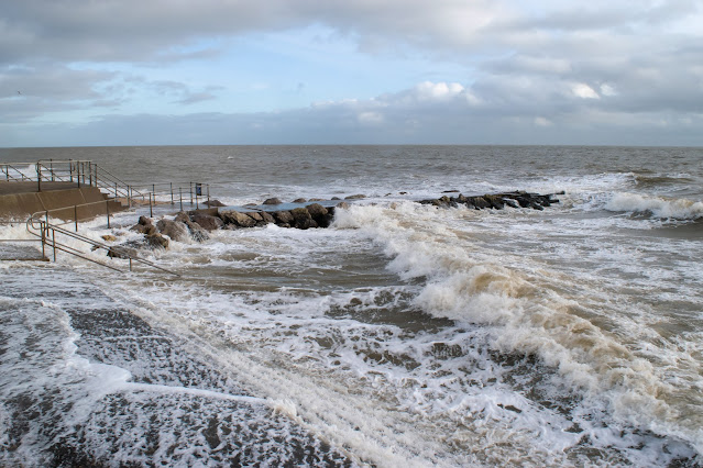 Tide crashes over sea wall