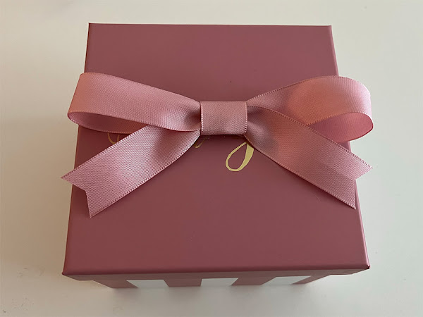 small decorated box, pink with a bow on top