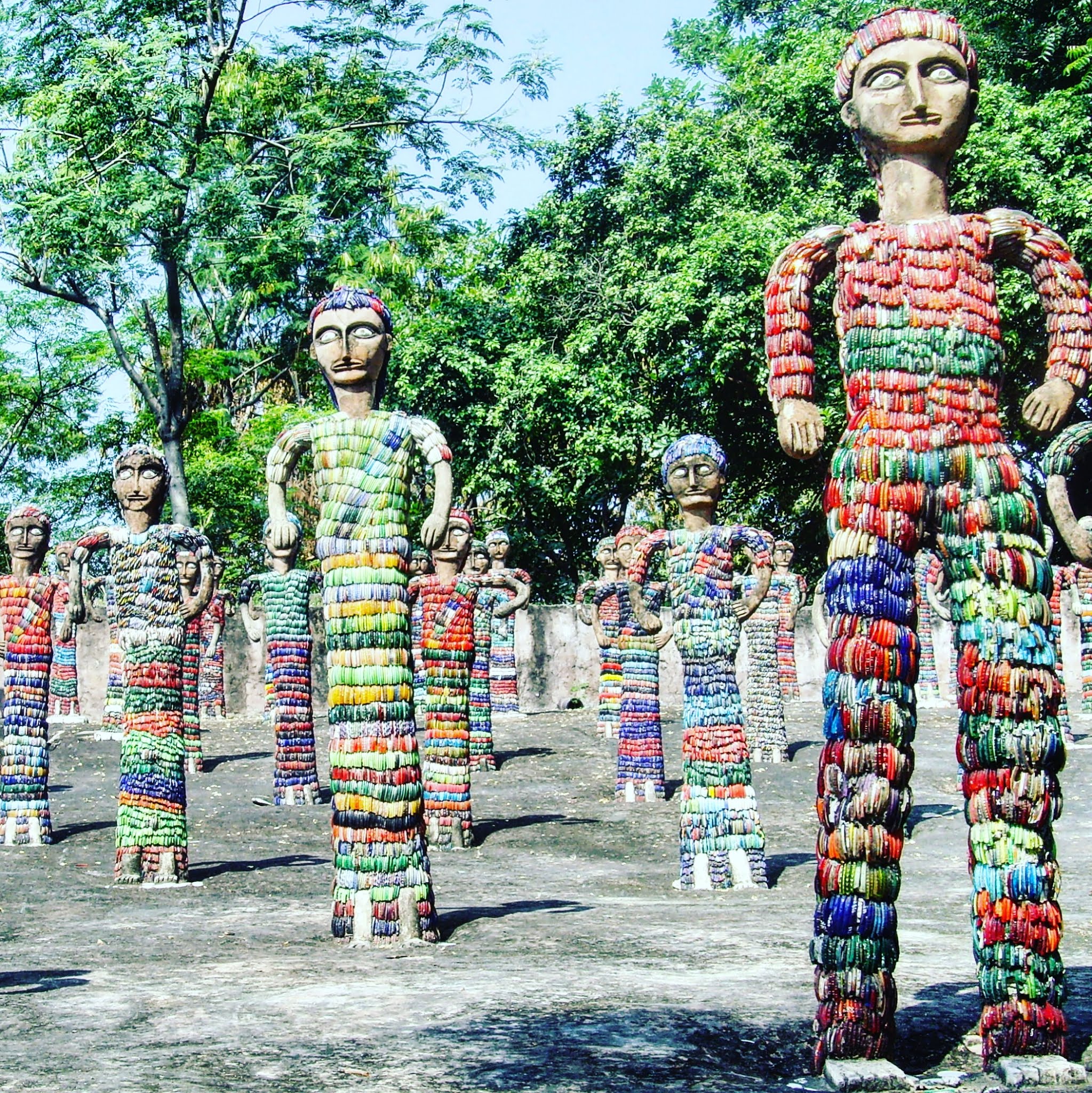 statues of women made from stone and broken bangles at the nek chand rock garden in chandigarh, India