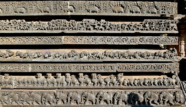 Elephants and lions on the first two rows followed by the floral designs and then the almost ruined horses, followed by another row of floral designs and then the episodes of Ramayana and Mahabharata, on the topmost row it must be kings  riding the Makaras .