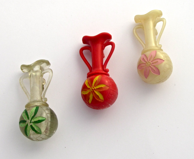 I have collected these three cute vintage plastic celluloid lucite vase