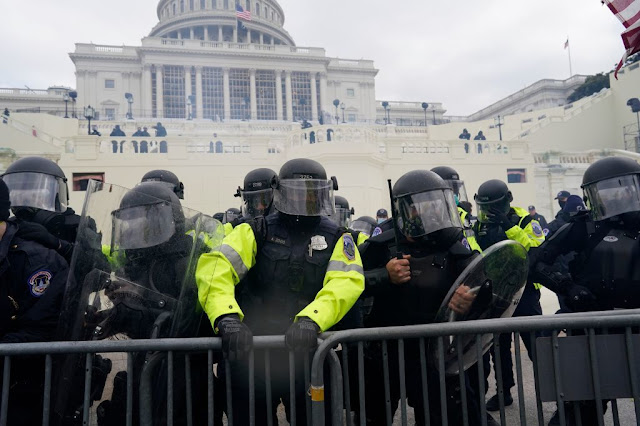 Two Capitol Police officers suspended and at least 10 more under investigation for alleged roles in riot