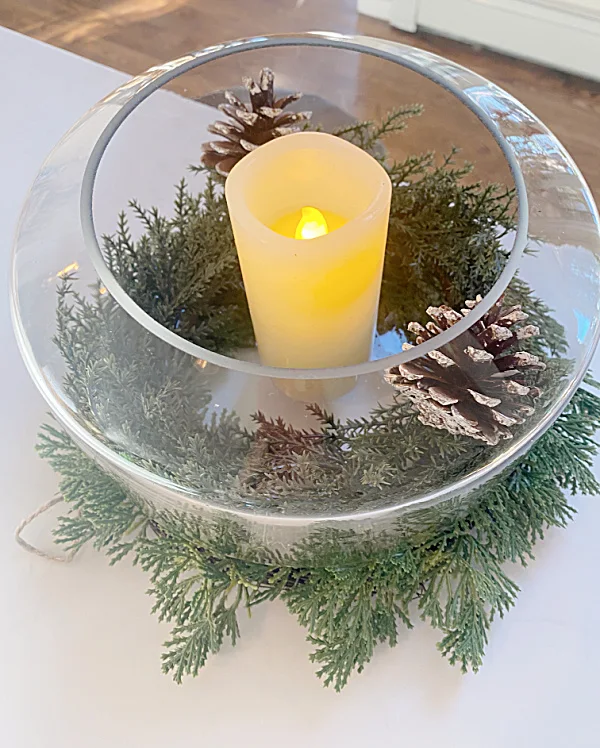 globe with candle and pinecones