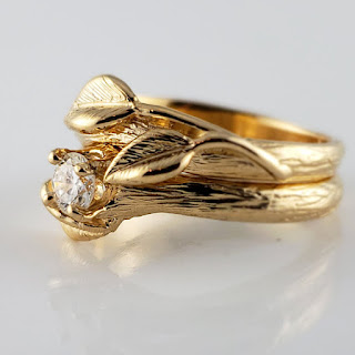 Hand sculpted branch style texture with three hand sculpted leaves cast in 14k yellow gold with a .25 natural diamond.