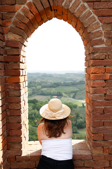 Katy in Hat Looking Over View of San Miniato Countryside from Rocco Tower, Tuscany, Italy