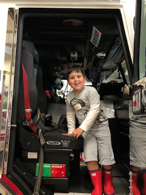 a boy in a fire truck