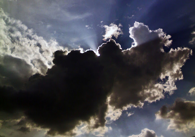 clouds silhouetted against the sun