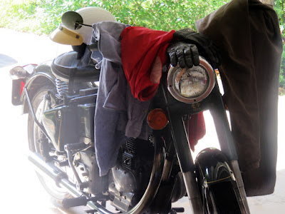 Royal Enfield draped with riding clothes.