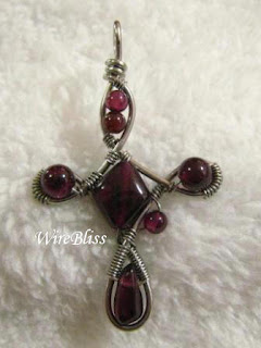 wire wrapped cross with garnet