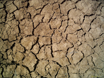 photo of cracked soil (dirt, earth) from lack of water during drought