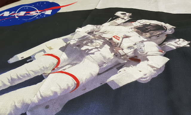 Iconic image of astronaut with Earth behind on bedding 