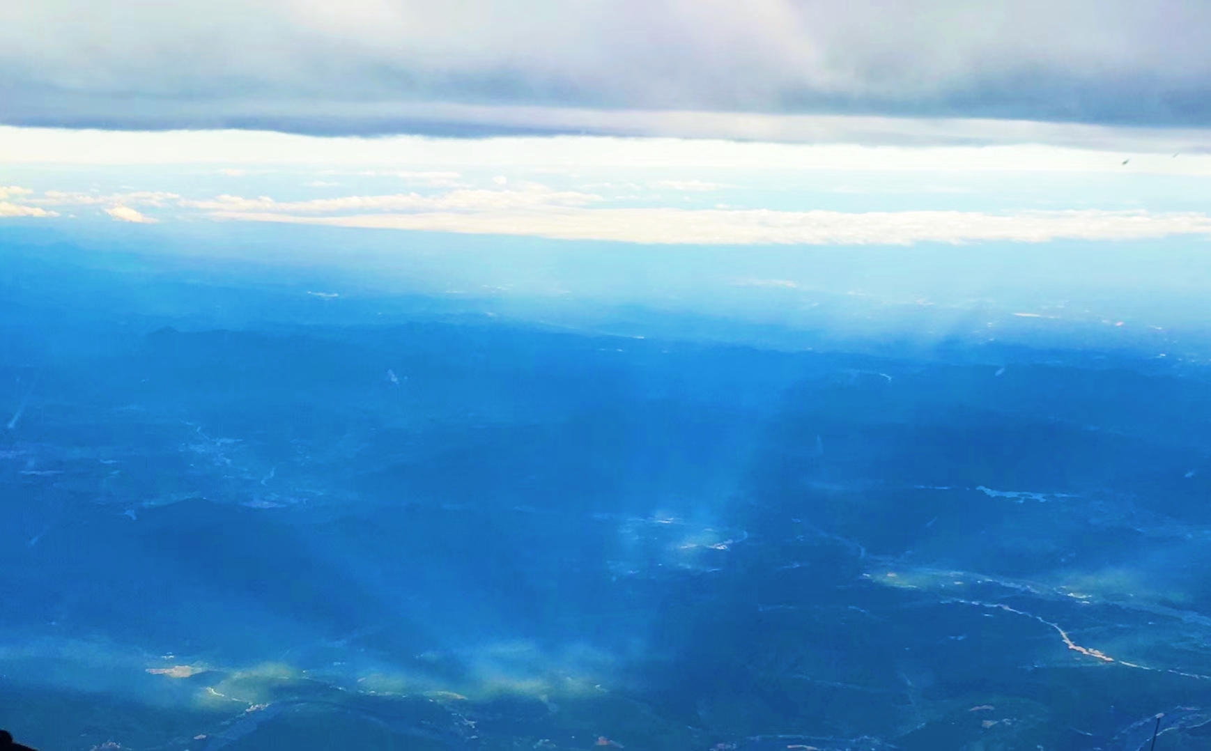 Great sunset views above the clouds outside the plane window