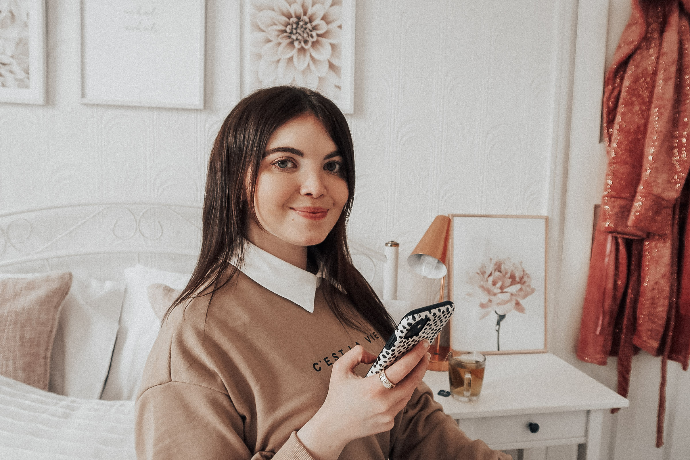 A woman holding an Iphone.