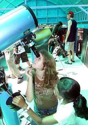 Curious kids: The international school students taking turns to look through the telescope.