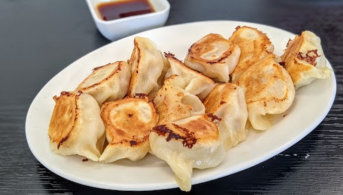 A combination of two orders: pork and napa cabbage dumplings and shrimp and chicken dumplings