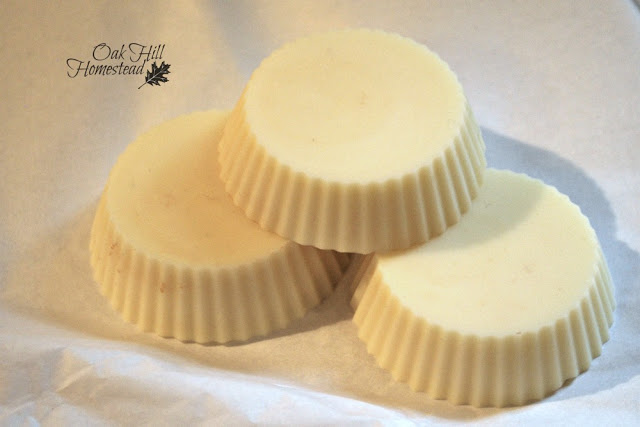 Three solid lotion bars on a white background