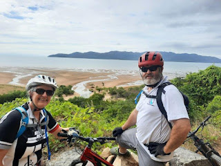 Two MTB riders overlooking water and island