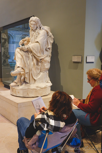 Artists painting inside the Louvre