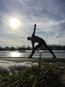 Triangle pose and streaky clouds before