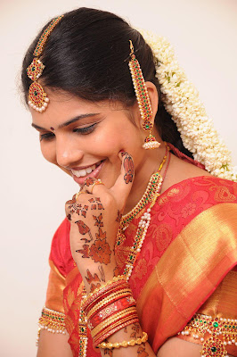 Cute smile by Indian bride Ananya decorated by ornaments. 