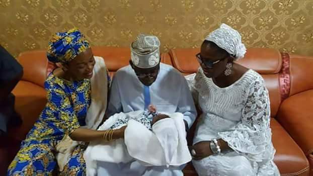 Photos: APC National leader, Bola Tinubu cradles his new grandson born through surrogacy