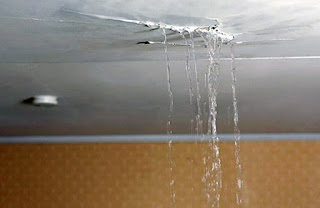 Water pouring out of a crack in the ceiling