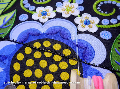 Using a beading koma to outline light blue petal with beads (Wild Child Japanese Bead Embroidery by Mary Alice Sinton)