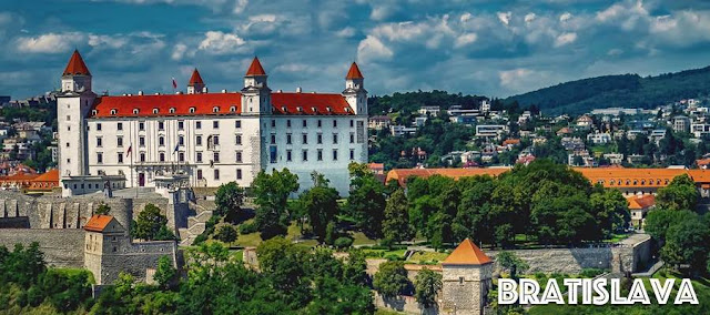 Bratislava castle with it's red tiled roof surrounded by the city
