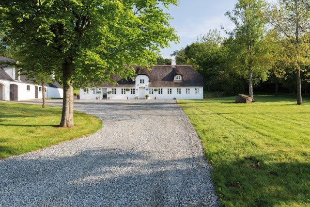 Gravel driveway and magnificent exterior of Danish farmhouse on Hello Lovely Studio