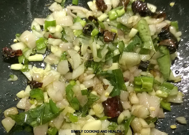 Adding garlic , chili, and curry leaves