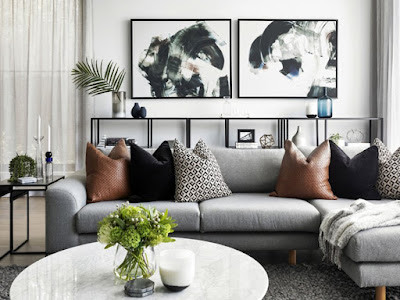 living room design with grey sofa tan leather cushions and marble coffee table