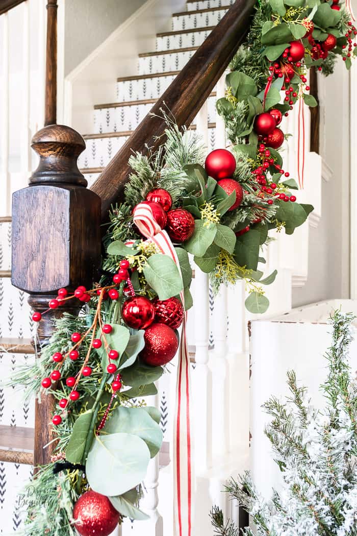 Christmas banister garland with multiple greenery, ornaments, berries and ribbon