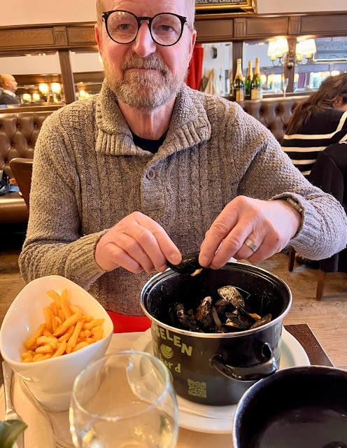 madmumof7's husband eating mussels from dark coloured enamel pot in Bruges, Belgium